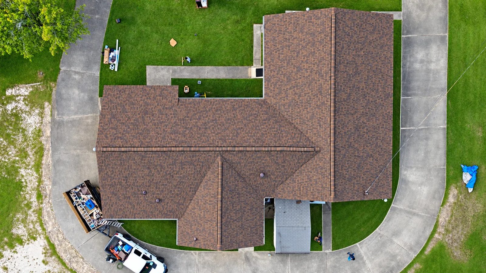 Top-down drone view of the completed CertainTeed Landmark Burnt Sienna shingle roof on Fresh Oil Full Gospel Church in Opelika, Alabama