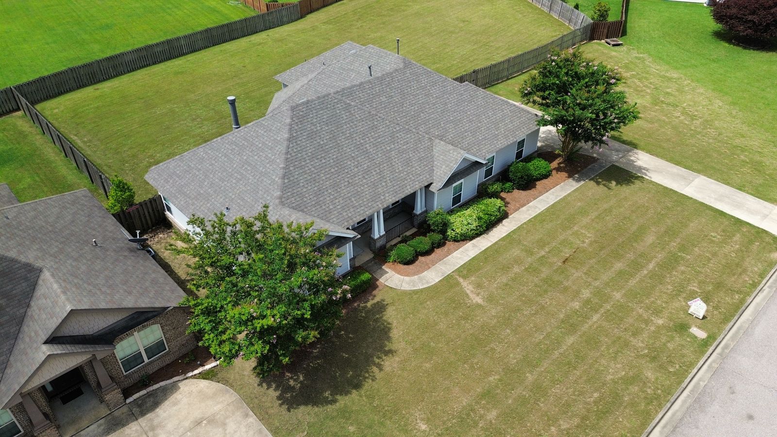 Drone view of a healthy architectural shingle roof on an Alabama home, the kind of full-roof documentation Precision Roofing Alabama provides with every inspection
